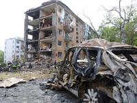 A burnt-out car is being pictured at a five-storey apartment block in the Holosiivskyi district destroyed by the Russian missile attack in K...