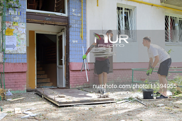 People are collecting the rubble at a five-storey apartment block in the Holosiivskyi district destroyed by the Russian missile attack in Ky...