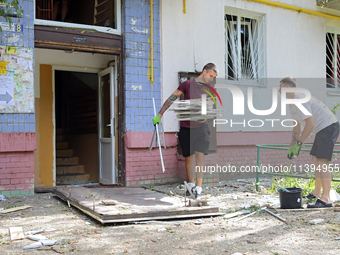 People are collecting the rubble at a five-storey apartment block in the Holosiivskyi district destroyed by the Russian missile attack in Ky...