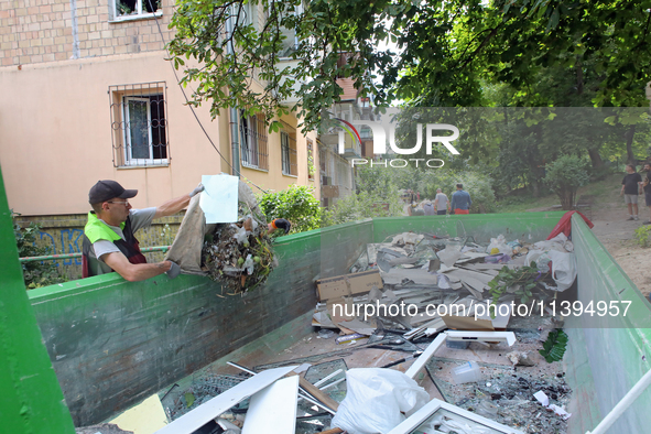 A man is throwing out the rubble at a five-storey apartment block in the Holosiivskyi district destroyed by the Russian missile attack in Ky...