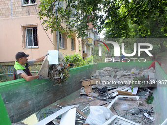 A man is throwing out the rubble at a five-storey apartment block in the Holosiivskyi district destroyed by the Russian missile attack in Ky...