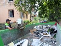 A man is throwing out the rubble at a five-storey apartment block in the Holosiivskyi district destroyed by the Russian missile attack in Ky...