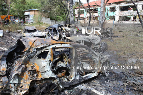 Burnt-out cars are being pictured at a kindergarten in the Holosiivskyi district destroyed by the Russian missile attack in Kyiv, Ukraine, o...