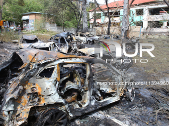 Burnt-out cars are being pictured at a kindergarten in the Holosiivskyi district destroyed by the Russian missile attack in Kyiv, Ukraine, o...