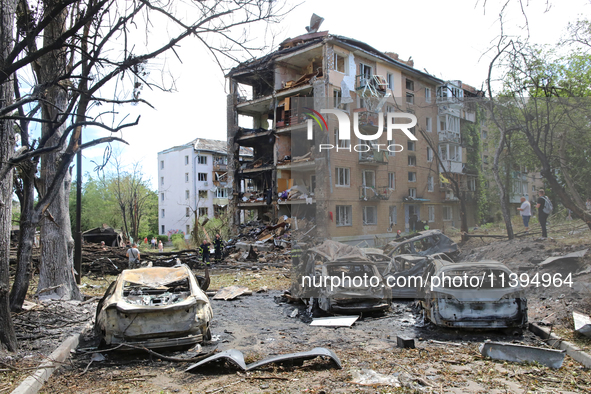 Burnt-out cars are being pictured at a five-storey apartment block in the Holosiivskyi district destroyed by the Russian missile attack in K...