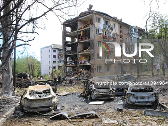 Burnt-out cars are being pictured at a five-storey apartment block in the Holosiivskyi district destroyed by the Russian missile attack in K...