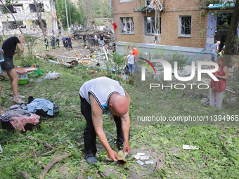 A man is looking for documents outside a five-storey apartment block in the Holosiivskyi district destroyed by the Russian missile attack in...