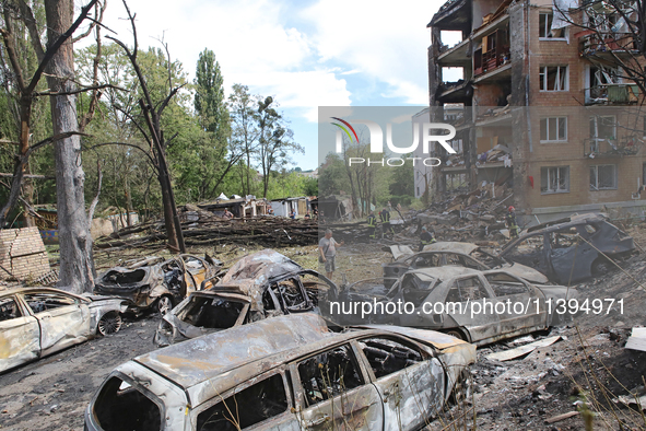 Burnt-out cars are being pictured at a five-storey apartment block in the Holosiivskyi district destroyed by the Russian missile attack in K...