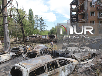 Burnt-out cars are being pictured at a five-storey apartment block in the Holosiivskyi district destroyed by the Russian missile attack in K...