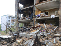 The interior of apartments is being pictured at a five-storey residential building in the Holosiivskyi district damaged by the Russian missi...