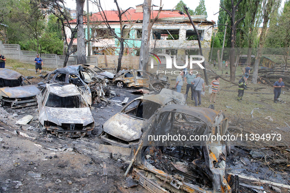 Burnt-out cars are being pictured at a kindergarten in the Holosiivskyi district destroyed by the Russian missile attack in Kyiv, Ukraine, o...