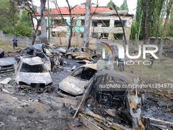 Burnt-out cars are being pictured at a kindergarten in the Holosiivskyi district destroyed by the Russian missile attack in Kyiv, Ukraine, o...