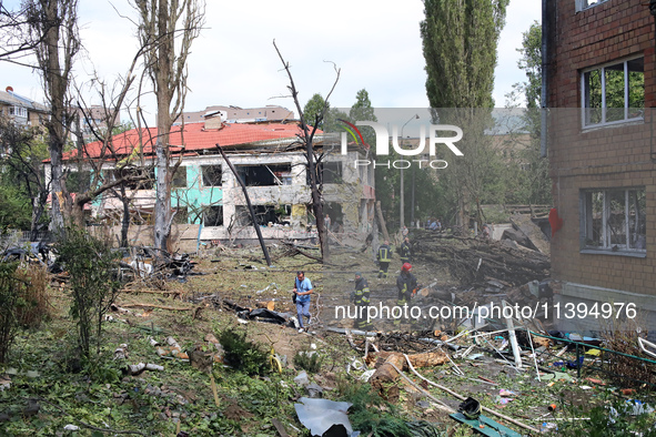 Rescuers are working near a kindergarten in the Holosiivskyi district destroyed by the Russian missile attack in Kyiv, Ukraine, on July 8, 2...