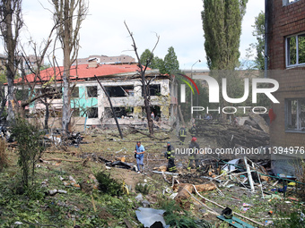 Rescuers are working near a kindergarten in the Holosiivskyi district destroyed by the Russian missile attack in Kyiv, Ukraine, on July 8, 2...