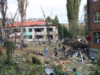 Rescuers are working near a kindergarten in the Holosiivskyi district destroyed by the Russian missile attack in Kyiv, Ukraine, on July 8, 2...