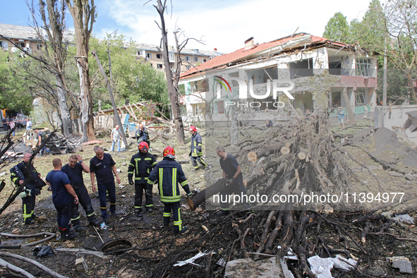 Rescuers are working near a kindergarten in the Holosiivskyi district destroyed by the Russian missile attack in Kyiv, Ukraine, on July 8, 2...