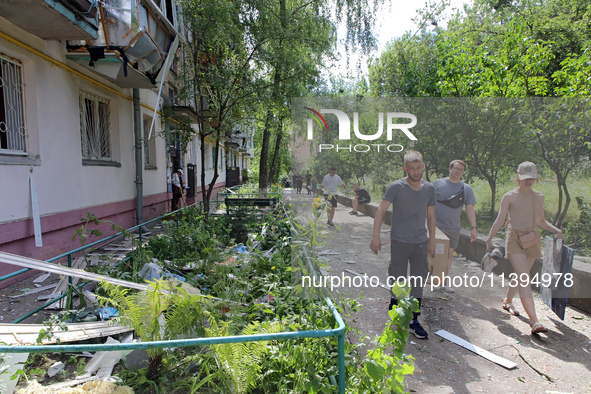 People are collecting the rubble at a five-storey apartment block in the Holosiivskyi district destroyed by the Russian missile attack in Ky...