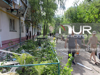 People are collecting the rubble at a five-storey apartment block in the Holosiivskyi district destroyed by the Russian missile attack in Ky...