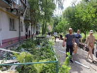 People are collecting the rubble at a five-storey apartment block in the Holosiivskyi district destroyed by the Russian missile attack in Ky...