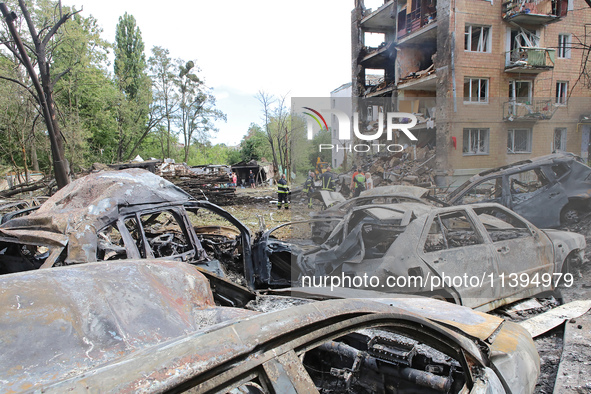 Burnt-out cars are being pictured at a five-storey apartment block in the Holosiivskyi district destroyed by the Russian missile attack in K...