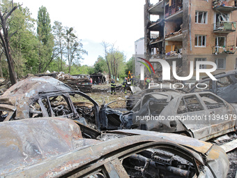 Burnt-out cars are being pictured at a five-storey apartment block in the Holosiivskyi district destroyed by the Russian missile attack in K...