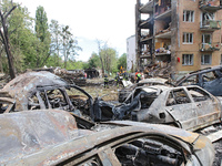 Burnt-out cars are being pictured at a five-storey apartment block in the Holosiivskyi district destroyed by the Russian missile attack in K...