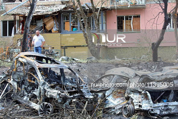 Burnt-out cars are being pictured at a five-storey apartment block in the Holosiivskyi district destroyed by the Russian missile attack in K...