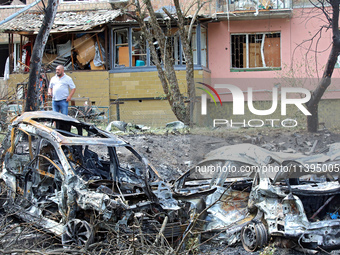 Burnt-out cars are being pictured at a five-storey apartment block in the Holosiivskyi district destroyed by the Russian missile attack in K...