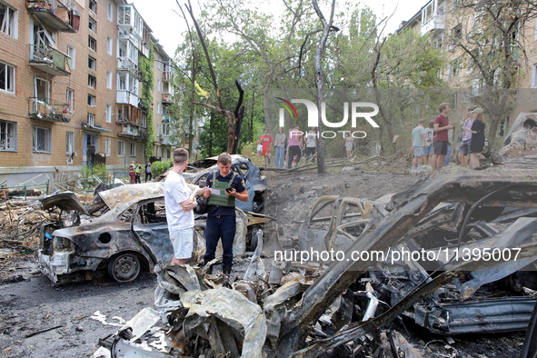 Burnt-out cars are being pictured at a five-storey apartment block in the Holosiivskyi district destroyed by the Russian missile attack in K...