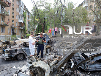 Burnt-out cars are being pictured at a five-storey apartment block in the Holosiivskyi district destroyed by the Russian missile attack in K...