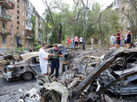 Burnt-out cars are being pictured at a five-storey apartment block in the Holosiivskyi district destroyed by the Russian missile attack in K...