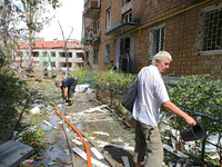 Rescuers and a man are being pictured at a five-storey apartment block in the Holosiivskyi district destroyed by the Russian missile attack...