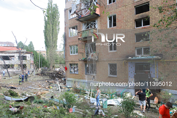 Burnt-out cars are being pictured at a five-storey apartment block in the Holosiivskyi district destroyed by the Russian missile attack in K...