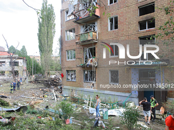 Burnt-out cars are being pictured at a five-storey apartment block in the Holosiivskyi district destroyed by the Russian missile attack in K...