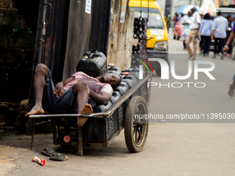 A water vendor is sleeping on his kegs of water as members of the Ministry of Environment in Lagos are embarking on a door-to-door campaign...