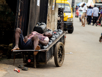 A water vendor is sleeping on his kegs of water as members of the Ministry of Environment in Lagos are embarking on a door-to-door campaign...