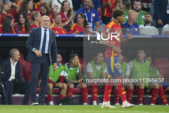 Miguel de la Fuente head coach of Spain congratulations to Lamine Yamal right winger of Spain and FC Barcelona during the UEFA EURO 2024 sem...