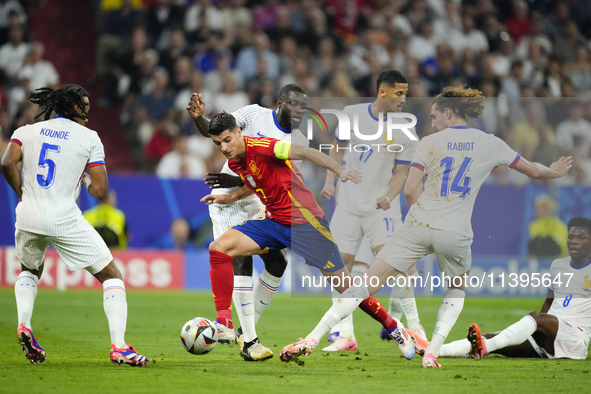 Alvaro Morata centre-forward of Spain and Atletico de Madrid surrounded by french players during the UEFA EURO 2024 semi-final match between...