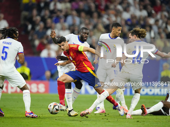 Alvaro Morata centre-forward of Spain and Atletico de Madrid surrounded by french players during the UEFA EURO 2024 semi-final match between...