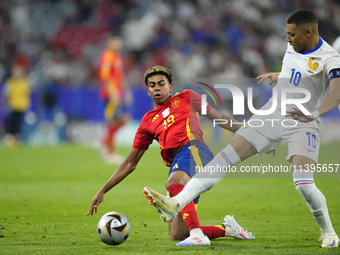 Lamine Yamal right winger of Spain and FC Barcelona and Kylian Mbappe centre-forward of France and Real Madrid compete for the ball during t...