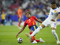 Lamine Yamal right winger of Spain and FC Barcelona and Kylian Mbappe centre-forward of France and Real Madrid compete for the ball during t...