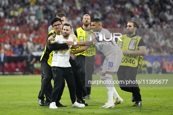 Pitch onvader with Kylian Mbappe centre-forward of France and Real Madrid during the UEFA EURO 2024 semi-final match between Spain v France...