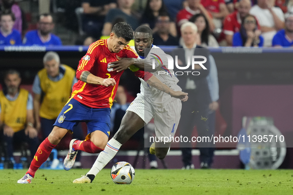 Alvaro Morata centre-forward of Spain and Atletico de Madrid and Dayot Upamecano centre-back of France and Bayern Munich compete for the bal...