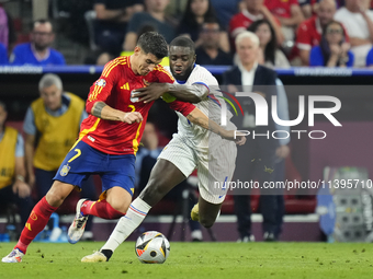 Alvaro Morata centre-forward of Spain and Atletico de Madrid and Dayot Upamecano centre-back of France and Bayern Munich compete for the bal...