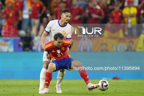 Mikel Oyarzabal centre-forward of Spain and Real Sociedad and William Saliba centre-back of France and Arsenal FC compete for the ball durin...