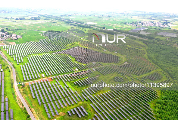 A photovoltaic power station is being shown in Ligang village, Chaohu city, East China's Anhui province, on July 9, 2024. 