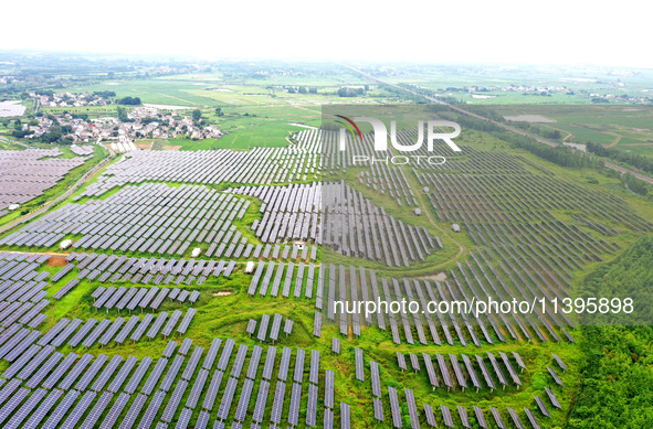 A photovoltaic power station is being shown in Ligang village, Chaohu city, East China's Anhui province, on July 9, 2024. 