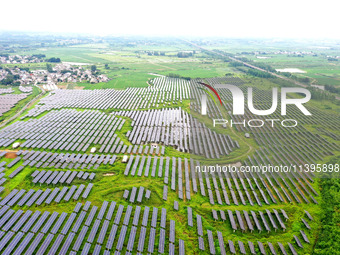 A photovoltaic power station is being shown in Ligang village, Chaohu city, East China's Anhui province, on July 9, 2024. (