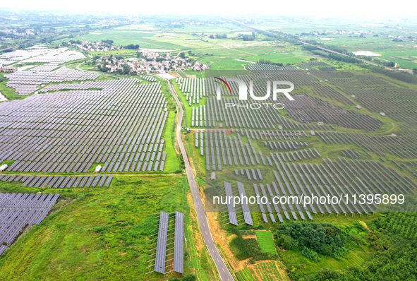 A photovoltaic power station is being shown in Ligang village, Chaohu city, East China's Anhui province, on July 9, 2024. 