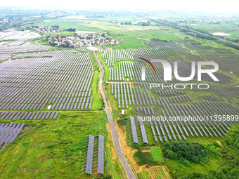 A photovoltaic power station is being shown in Ligang village, Chaohu city, East China's Anhui province, on July 9, 2024. (